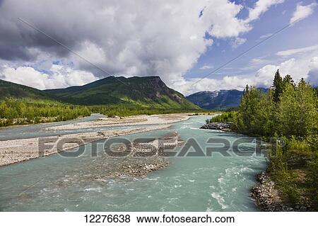 Scenic view of the Racing River along the Alaska Highway, British Columbia, Canada View Large Photo Image Stock Photo - Scenic view of the Racing River along the Alaska Highway, British Columbia, Canada. Fotosearch