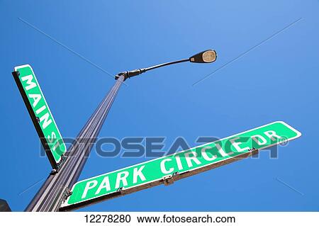 Street signs at an intersection against a blue sky; Wheaton, Illinois, United States of America View Large Photo Image Stock Image - Street signs at an intersection against a blue sky; Wheaton, Illinois, United States of America. Fotosearch