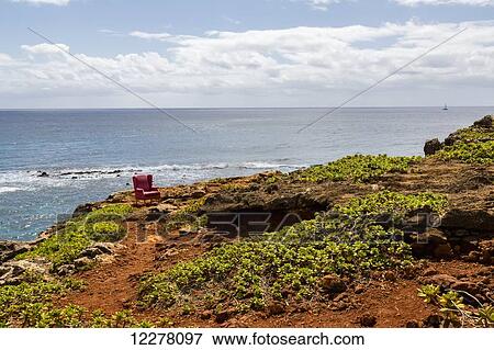 View of a red stuffed arm chair placed on a cliff edge; Poipu, Kauai, Hawaii, United States of America View Large Photo Image Stock Photo - View of a red stuffed arm chair placed on a cliff edge; Poipu, Kauai, Hawaii, United States of America. Fotosearch