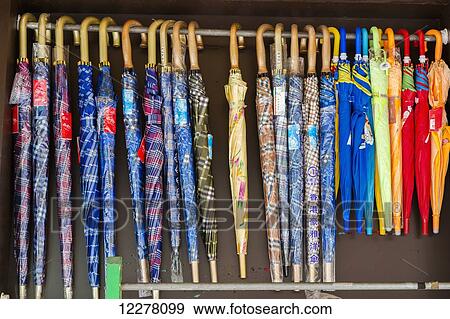 View of colorful umbrellas hanging in an outdoor shop in Chinatown; Honolulu, Oaho, Hawaii, United States of America View Large Photo Image Stock Photo - View of colorful umbrellas hanging in an outdoor shop in Chinatown; Honolulu, Oaho, Hawaii, United States of America. Fotosearch