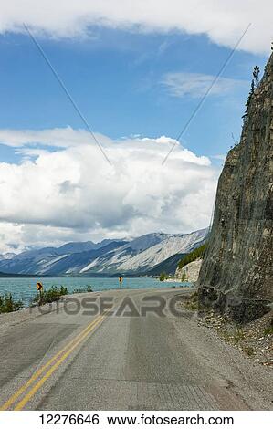View of the Alaska Highway along the shore of Muncho Lake, Muncho Lake Provincial Park, British Columbia, Canada, Summer View Large Photo Image Stock Photograph - View of the Alaska Highway along the shore of Muncho Lake, Muncho Lake Provincial Park, British Columbia, Canada, Summer. Fotosearch