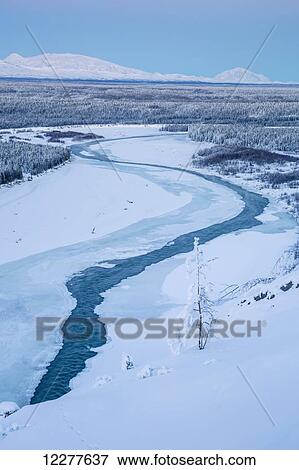 Stock Photo - View of the Wrangell Mountains above the Copper River Valley at dusk, Southcentral Alaska, Winter. Fotosearch