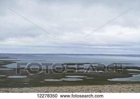 Stock Image - View of tundra and ocean from Mount Pelly, near Cambridge Bay; Nunavut, Canada. Fotosearch
