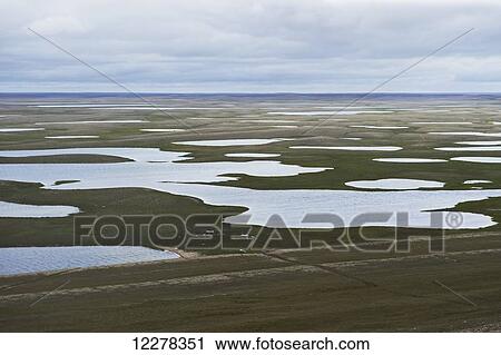Stock Image - View of tundra and ocean from Mount Pelly, near Cambridge Bay; Nunavut, Canada. Fotosearch