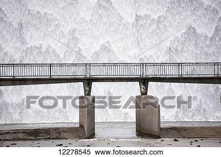 Water cascading down a reservoir overflow outlet, Wet Sleddale; Cumbria, England View Large Photo Image Stock Photography - Water cascading down a reservoir overflow outlet, Wet Sleddale; Cumbria, England. Fotosearch