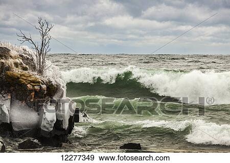 Stock Photo - Waves of Lake Superior, ice and rocks along the shoreline; Thunder Bay, Ontario, Canada. Fotosearch
