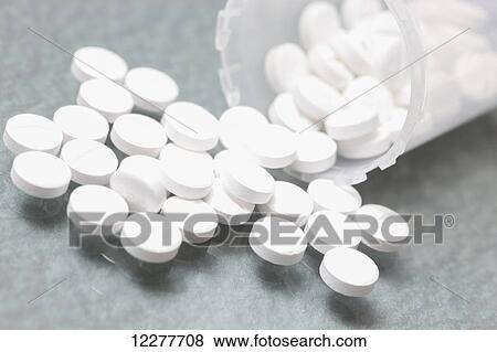 Stock Photo - White pills in clear plastic bottles; Edmonton, Alberta, Canada. Fotosearch