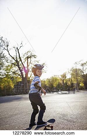 Stock Image - Young boy riding a skateboard; Montreal, Quebec, Canada. Fotosearch