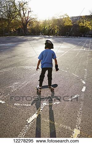 Stock Photography - Young boy riding a skateboard; Montreal, Quebec, Canada. Fotosearch