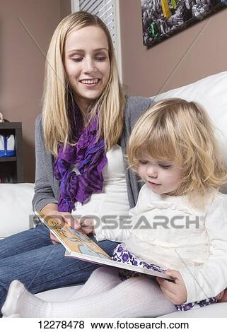 Young disabled mother reading to her toddler daughter on a couch; Spruce Grove, Alberta, Canada View Large Photo Image Stock Photo - Young disabled mother reading to her toddler daughter on a couch; Spruce Grove, Alberta, Canada. Fotosearch