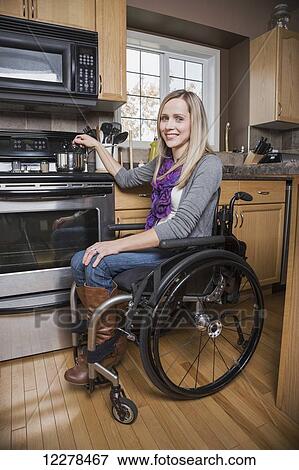Young disabled woman cooking in her kitchen; Spruce Grove, Alberta, Canada View Large Photo Image Stock Photo - Young disabled woman cooking in her kitchen; Spruce Grove, Alberta, Canada. Fotosearch