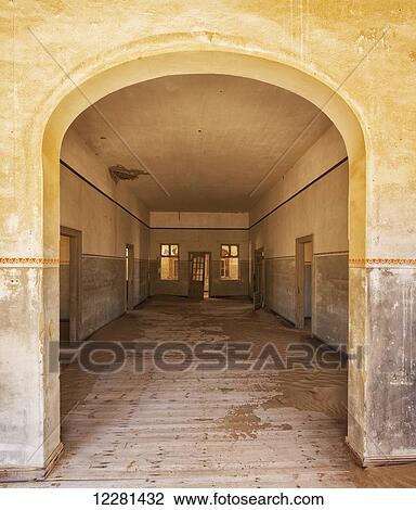 Stock Image - A colourful and abandoned house; Kolmanskop, Namibia. Fotosearch