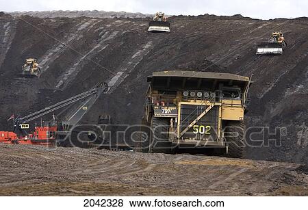 Stock Photo - A Dump Truck Carries A 400 Ton Load Of Oil Sands Ore, Mining Operation, Fort Mcmurray, Alberta. Fotosearch