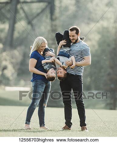 A family with young children playing in a park; Edmonton, Alberta, Canada View Large Photo Image Stock Photograph - A family with young children playing in a park; Edmonton, Alberta, Canada. Fotosearch