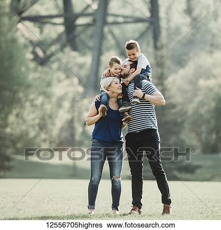 A family with young children playing in a park; Edmonton, Alberta, Canada View Large Photo Image Stock Photograph - A family with young children playing in a park; Edmonton, Alberta, Canada. Fotosearch