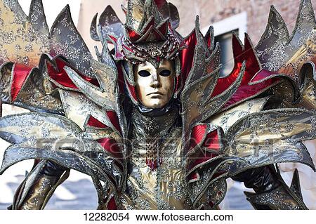 Picture - A person in an ornate costume and mask; Venice, Italy. Fotosearch