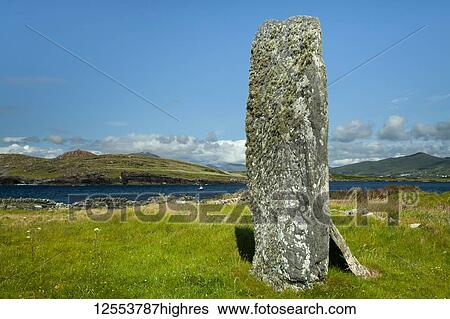 A tall stone structure on the grass field along the coast of Iveragh Peninsula, Ring of Kerry, Skellig Ring, Wild Atlantic Way; Valentia Island, County Kerry, Ireland View Large Photo Image Stock Photograph - A tall stone structure on the grass field along the coast of Iveragh Peninsula, Ring of Kerry, Skellig Ring, Wild Atlantic Way; Valentia Island, County Kerry, Ireland. Fotosearch