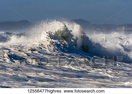Stock Photograph - A wave breaks at Seaside Cove; Seaside, Oregon, United States of America. Fotosearch