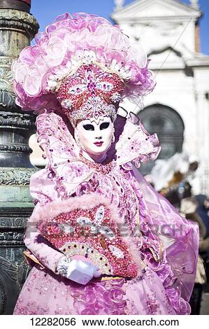 Stock Photograph - A woman in a glamorous pink costume; Venice, Italy. Fotosearch