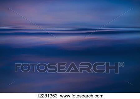 Stock Image - Abstract ocean patterns at sunrise; Lanikai, Oahu, Hawaii, United States of America. Fotosearch