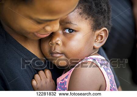 African child in arms of her mother; Hammanskraal, Gautang, South Africa View Large Photo Image Stock Image - African child in arms of her mother; Hammanskraal, Gautang, South Africa. Fotosearch