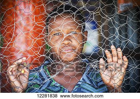 African woman standing behind chicken wire; Maun, Botswana View Large Photo Image Stock Photo - African woman standing behind chicken wire; Maun, Botswana. Fotosearch
