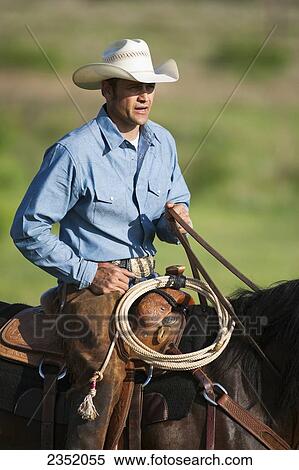 Agriculture - A cowboy on horseback on a western rangeland / Childress, Texas, USA. View Large Photo Image Stock Photography - Agriculture - A cowboy on horseback on a western rangeland / Childress, Texas, USA.. Fotosearch