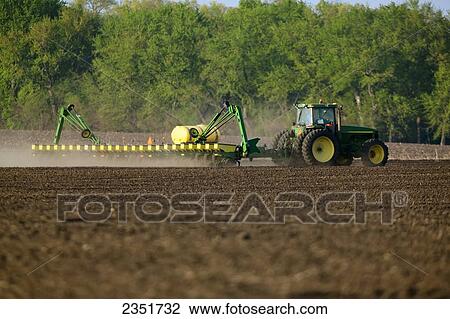 Agriculture - A John Deere tractor and 24-row planter planting corn in a conventionally tilled field / Minnesota, USA. View Large Photo Image Stock Image - Agriculture - A John Deere tractor and 24-row planter planting corn in a conventionally tilled field / Minnesota, USA.. Fotosearch