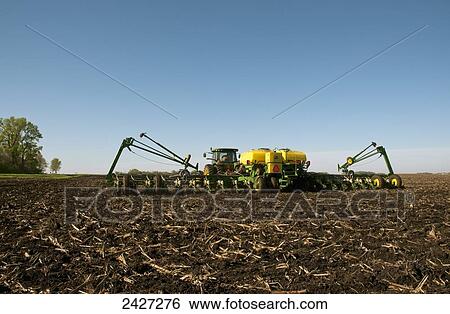 Agriculture - A tractor and 24-row planter planting minimum till corn in spring / near Truman, Minnesota, USA. View Large Photo Image Stock Photograph - Agriculture - A tractor and 24-row planter planting minimum till corn in spring / near Truman, Minnesota, USA.. Fotosearch