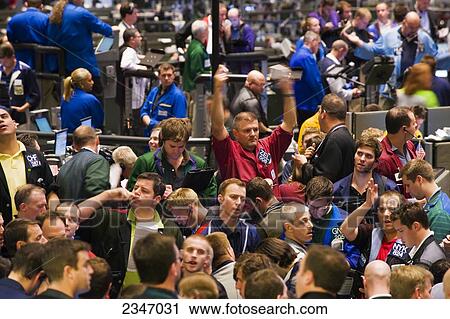 Stock Image - Agriculture - Commodities traders working on the interior trading floor of the Chicago Board of Trade and Commodities Exchange / Chicago, Illinois, USA.. Fotosearch