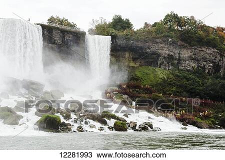 American Falls and tourists in yellow raincoats climbing the walkway; Niagara Falls, New York, USA View Large Photo Image Stock Image - American Falls and tourists in yellow raincoats climbing the walkway; Niagara Falls, New York, USA. Fotosearch