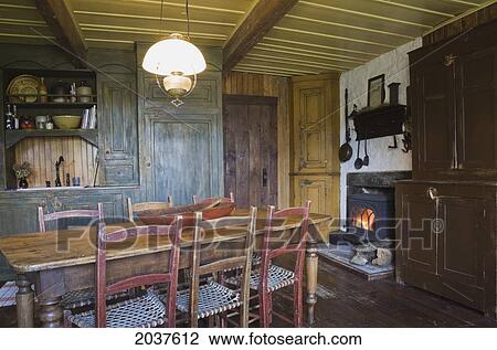 Antique Wooden Dining Table And Chairs In The Kitchen Of An Old