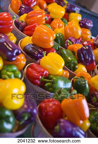 Stock Image - Baskets Of Red, Orange, Yellow, Green, And Purple Bell Peppers On Display At A Market, Montreal, Quebec. Fotosearch