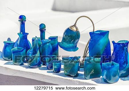 Stock Photography - Beautiful Mediterranean blue handmade glass decorative art pieces on display to be sold to tourists for souvenir gifts; Santorini, Greece. Fotosearch