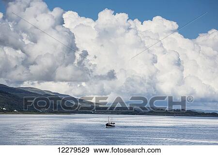 Billowing cloud and a boat in the ocean off the coast; Isle of Mull, Argyll and Bute, Scotland View Large Photo Image Stock Photo - Billowing cloud and a boat in the ocean off the coast; Isle of Mull, Argyll and Bute, Scotland. Fotosearch