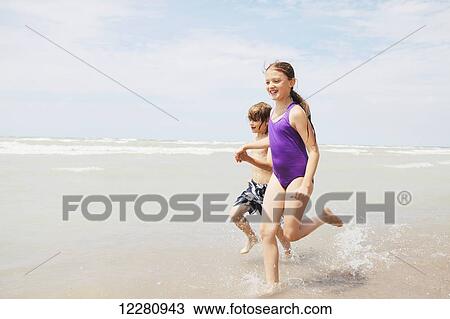 Boy and girl running on beach; Grand Bend, Ontario, Canada View Large Photo Image Stock Image - Boy and girl running on beach; Grand Bend, Ontario, Canada. Fotosearch