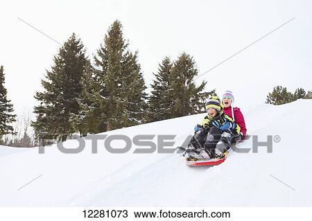 Boy and girl tobogganing; King City, Ontario, Canada View Large Photo Image Stock Image - Boy and girl tobogganing; King City, Ontario, Canada. Fotosearch
