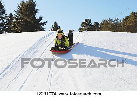Picture - Boy tobogganing; King City, Ontario, Canada. Fotosearch