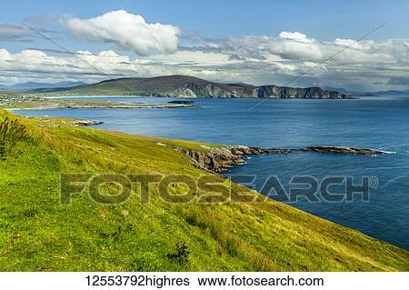 Bright blue water and lush green grass along the coastline of Achill Island on the Wild Atlantic Way; Achill Island, County Mayo, Ireland View Large Photo Image Stock Photograph - Bright blue water and lush green grass along the coastline of Achill Island on the Wild Atlantic Way; Achill Island, County Mayo, Ireland. Fotosearch