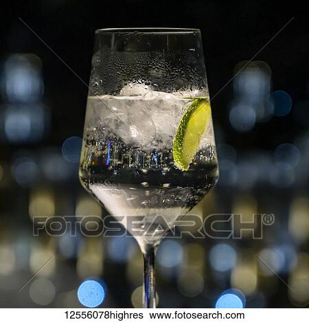 Carbonated water with lime wedge and ice cubes in a glass; Havana, Cuba View Large Photo Image Stock Photograph - Carbonated water with lime wedge and ice cubes in a glass; Havana, Cuba. Fotosearch