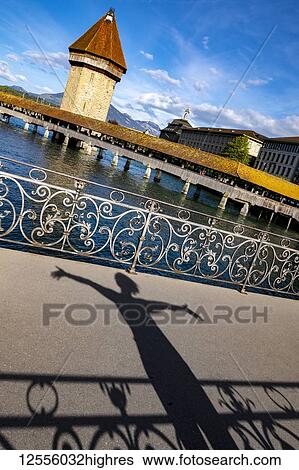 Chapel bridge over the River Reuss and shadow of tourist; Lucerne, Lucerne, Switzerland View Large Photo Image Stock Photograph - Chapel bridge over the River Reuss and shadow of tourist; Lucerne, Lucerne, Switzerland. Fotosearch