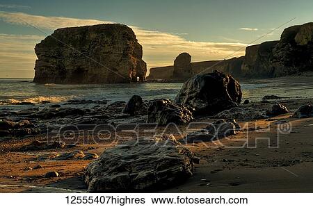 Stock Photograph - Cliffs, rocks and sea stacks along the Atlantic coast; South Shields, Tyne and Wear, England. Fotosearch