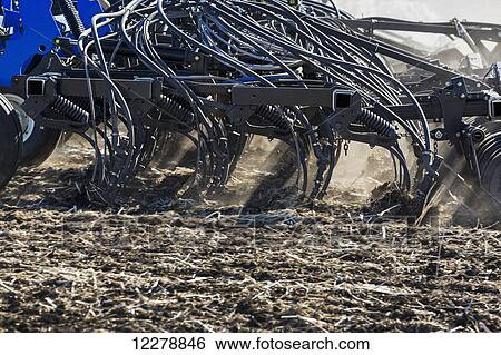 Close up of air seeder tilling the soil and planting; Alberta, Canada View Large Photo Image Stock Photograph - Close up of air seeder tilling the soil and planting; Alberta, Canada. Fotosearch