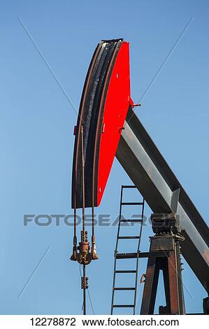 Close up of pump jack and blue sky; Alberta, Canada View Large Photo Image Stock Image - Close up of pump jack and blue sky; Alberta, Canada. Fotosearch