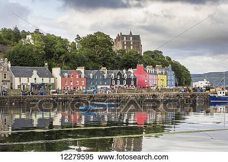 Stock Photography - Colourful, buildings along the waterfront with boats moored in the tranquil harbour; Tobermory, Isle of Mull, Argyll and Bute, Scotland. Fotosearch