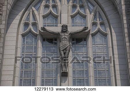 Stock Image - Crucifix on exterior of Saint-Michel Basilica-Cathedral; Sherbrooke, Quebec, Canada. Fotosearch