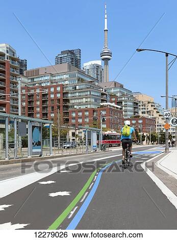 Cyclist on bicycle path at Harbourfront; Toronto, Ontario, Canada View Large Photo Image Stock Photograph - Cyclist on bicycle path at Harbourfront; Toronto, Ontario, Canada. Fotosearch