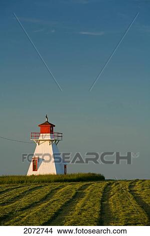 Picture - Darnley Lighthouse And Field Of Cut Hay, Prince Edward Island. Fotosearch