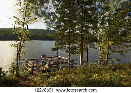 Deck over a lake in late afternoon; Lac-des-Neiges, Quebec, Canada View Large Photo Image Stock Image - Deck over a lake in late afternoon; Lac-des-Neiges, Quebec, Canada. Fotosearch