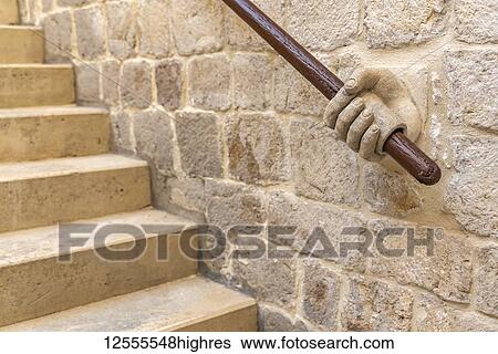 Stock Photograph - Decorative handrail of human hand holding rail, inside the Rector's Palace; Dubrovnik, Dubrovnik-Neretva County, Croatia. Fotosearch